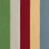 Multicolor curtain fabric swatch with vertical stripes in red, green, ivory, yellow, and blue.