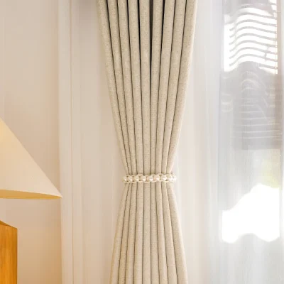 Close-up of beige high-density curtain fabric with natural drape and elegant texture