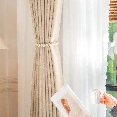 Beige high-density curtain with sheer drape in a cozy reading nook by the window
