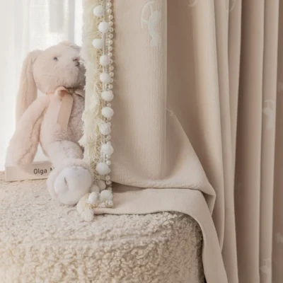 Soft pink rocking horse curtain next to plush toy – jacquard kids curtain with light filtering texture for nursery