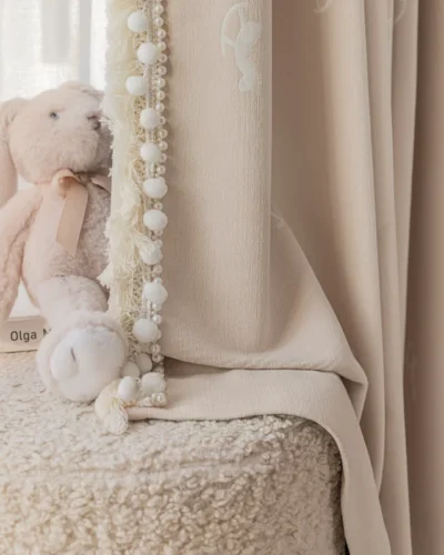 Soft pink rocking horse curtain next to plush toy – jacquard kids curtain with light filtering texture for nursery