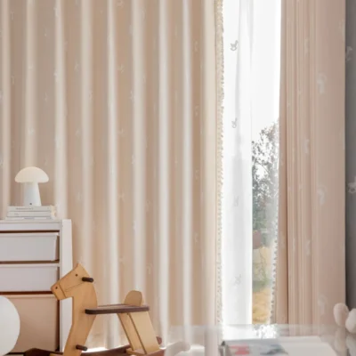 Rocking horse jacquard curtain in pastel pink softly filtering light in a kids’ room with wooden toys