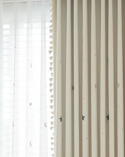 Double-layer curtain view showing Starry Weave outer jacquard with embroidered stars and inner sheer panel