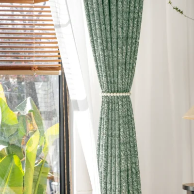 Green printed curtain hanging straight with sunlight and garden background – Verdant Maze by Lemonhone