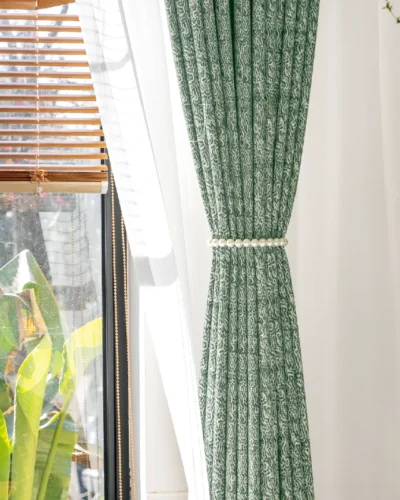 Green printed curtain hanging straight with sunlight and garden background – Verdant Maze by Lemonhone