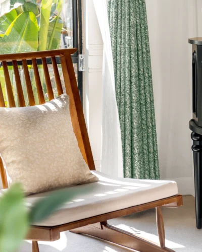 Green printed curtain styled in natural light with wood chair – Verdant Maze by Lemonho