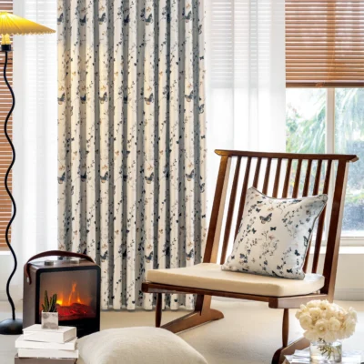 Butterfly print curtains styled in a cozy living space with natural light and wooden furniture.