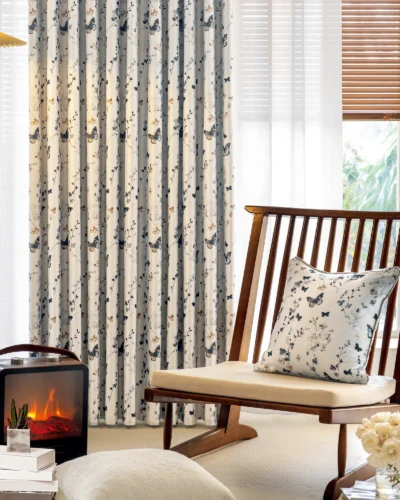 Butterfly print curtains styled in a cozy living space with natural light and wooden furniture.