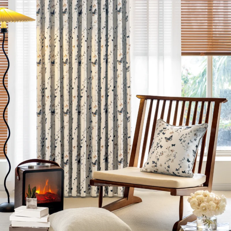 Butterfly print curtains styled in a cozy living space with natural light and wooden furniture.