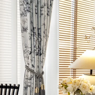 Ink bamboo curtain pulled open beside window with natural light and floral decor