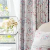 Botanical print curtain with bird and floral motifs, sheer white layer, and soft accents.
