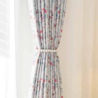 Bird and floral curtain tied back with soft pleats and vintage-style print