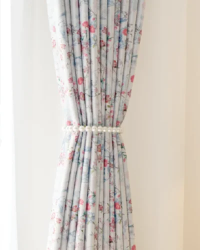 Bird and floral curtain tied back with soft pleats and vintage-style print