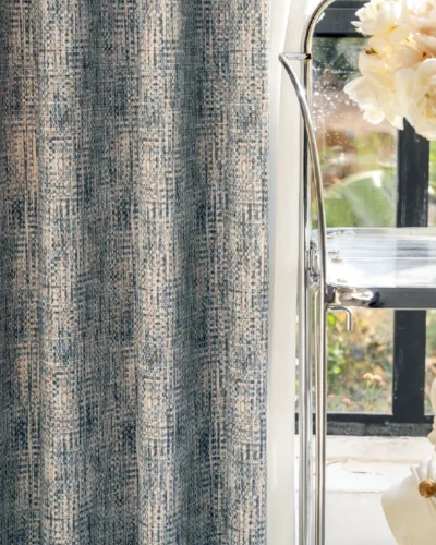 Woven Print Curtain in indigo and beige with faux textured pattern, softly draped near a window with natural light and floral decor