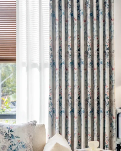 Dreamy Meadow watercolor floral curtains hanging by a window, softly filtering natural light into a serene living space