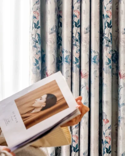 Watercolor floral curtain in living room – Dreamy Meadow drapes in soft blue and blush, styled with neutral sofa and flowers