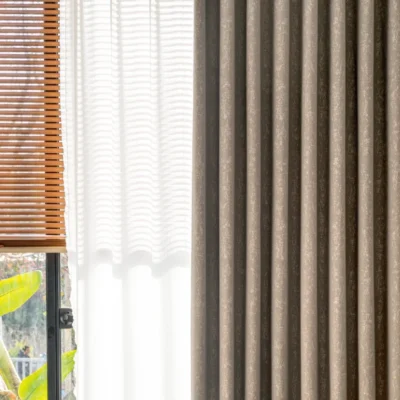 Gold-tone texture curtain in modern interior, softly filtering daylight through precision-woven fabric.