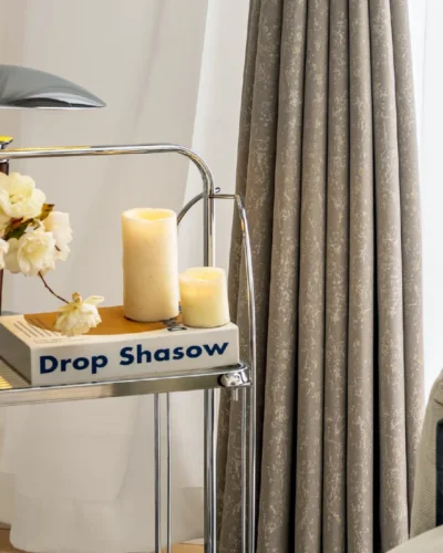 High-density gilded texture curtain in beige color, softly glowing in daylight with elegant folds.