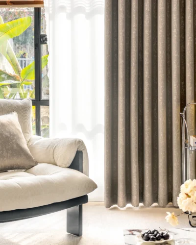 Gold-tone texture curtain in modern living room with soft fabric glow and layered decor.