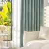 Living room with blue-grey dragonfly texture curtains and soft natural lighting.