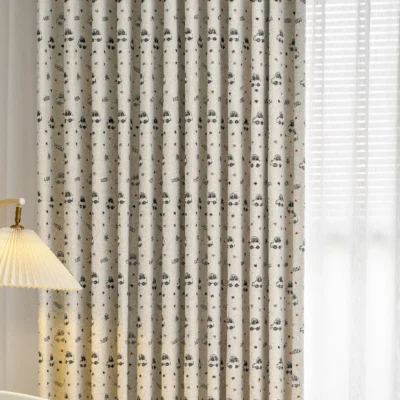 Close-up of cartoon car print curtain fabric with stars in neutral tones