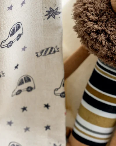 Close-up of cartoon car curtain fabric with candy and star prints in kids room