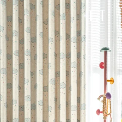 Side view of smiling cloud curtain layered with white sheers in kids room