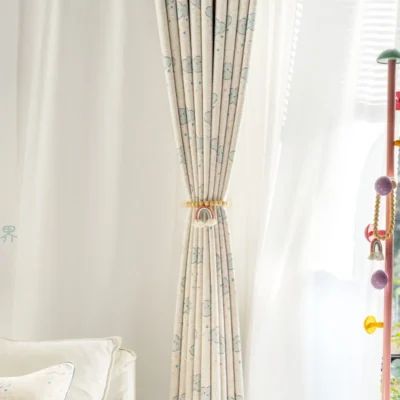 Smiling cloud curtain pulled back with tieback in a bright children’s room