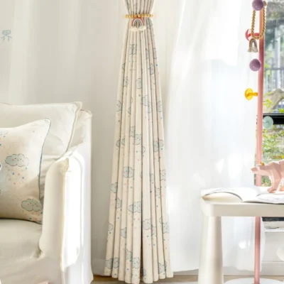 Full-length smiling cloud curtain with tieback and white sheers in kids room