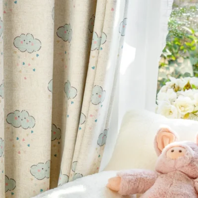 Close-up of smiling cloud curtain next to plush toy in a baby room