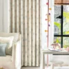 Smiling cloud curtain with pastel raindrop print hanging in a bright children’s room