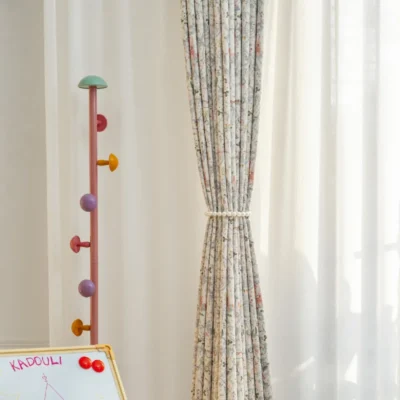 Fairy tale curtain tied back with soft pleats and pastel storybook print for kids