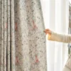 Person holding fairy tale garden curtain to show pastel storybook print for kids
