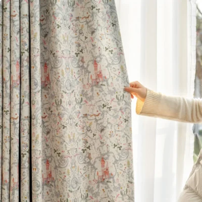 Person holding fairy tale garden curtain to show pastel storybook print for kids