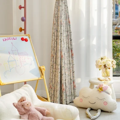 Fairy tale curtain with storybook castle print in a cozy children's room with toys and sunlight