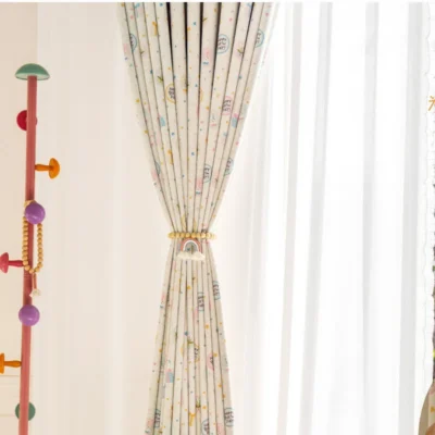 Close-up of Happy Day Curtain tied to the side, showing playful birthday-themed print
