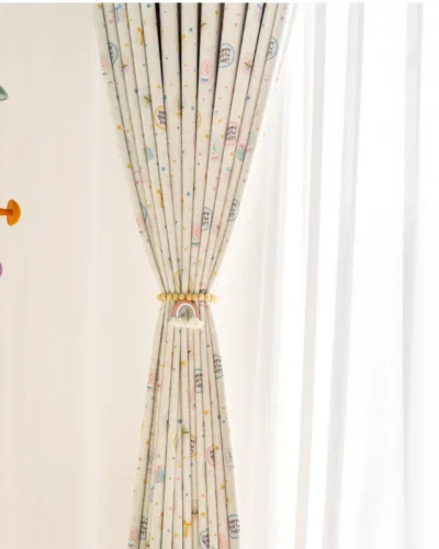 Close-up of Happy Day Curtain tied to the side, showing playful birthday-themed print