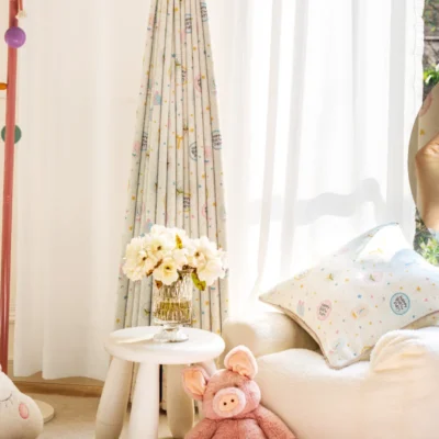 Happy Day Curtain hanging in a bright kids’ room with plush toys and colorful decor