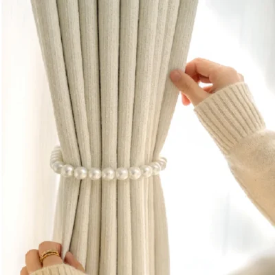 Close-up of decorative beaded tieback on light grey curtain from Ivory Breeze Collection