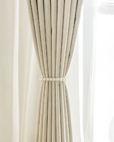 Herringbone texture curtain tied back for soft natural light