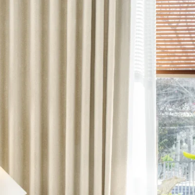 Herringbone texture curtain with soft light filtering near wooden blinds