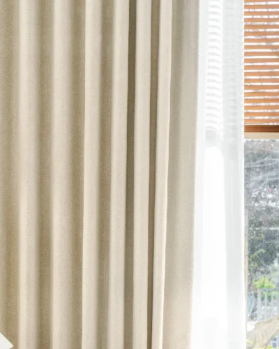 Herringbone texture curtain with soft light filtering near wooden blinds