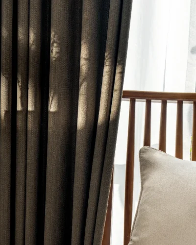 Earthline Curtain in charcoal brown filtering daylight – close-up view with soft shadows and fabric texture by Lemonhone.