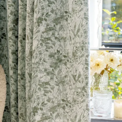 Botanical jacquard curtain hanging by window with soft nature-inspired pattern