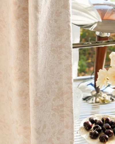 Botanical jacquard curtain styled with glassware and dried florals by the window