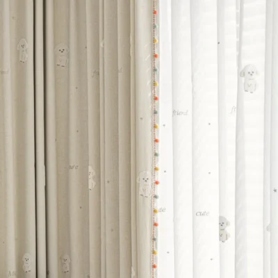 Close-up of Friendly Pup Curtain – beige jacquard and white sheer layers with dog embroidery and colorful trim