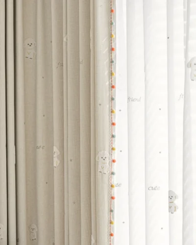 Close-up of Friendly Pup Curtain – beige jacquard and white sheer layers with dog embroidery and colorful trim