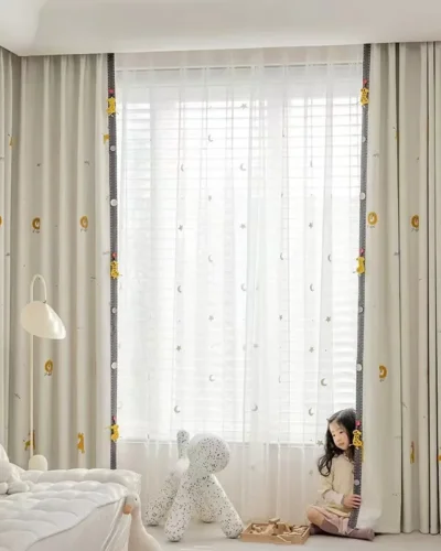 Measuring Forest King Curtain during installation – close-up of jacquard fabric and playful lion tieback