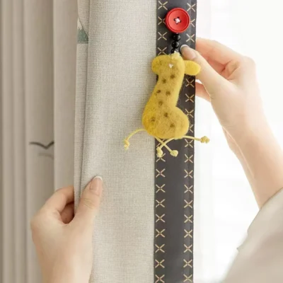 Close-up of Forest King Curtain installation – attaching lion curtain tieback in a kids’ room