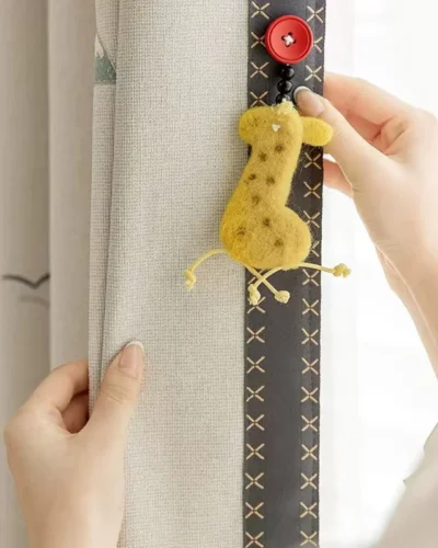 Close-up of Forest King Curtain installation – attaching lion curtain tieback in a kids’ room